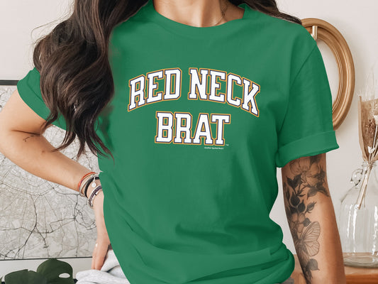 Green t-shirt with white and yellow "RED NECK BRAT" text.