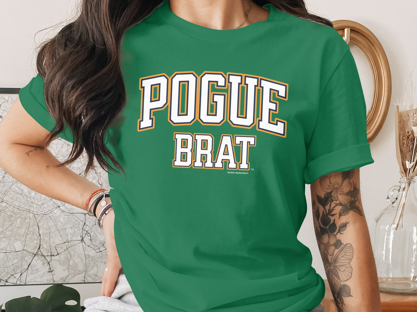 Green t-shirt with "POGUE BRAT" written in block letters.