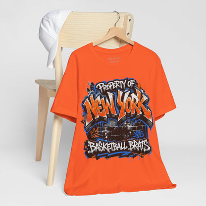 Orange t-shirt with "Property of New York Basketball Brats" graffiti design.