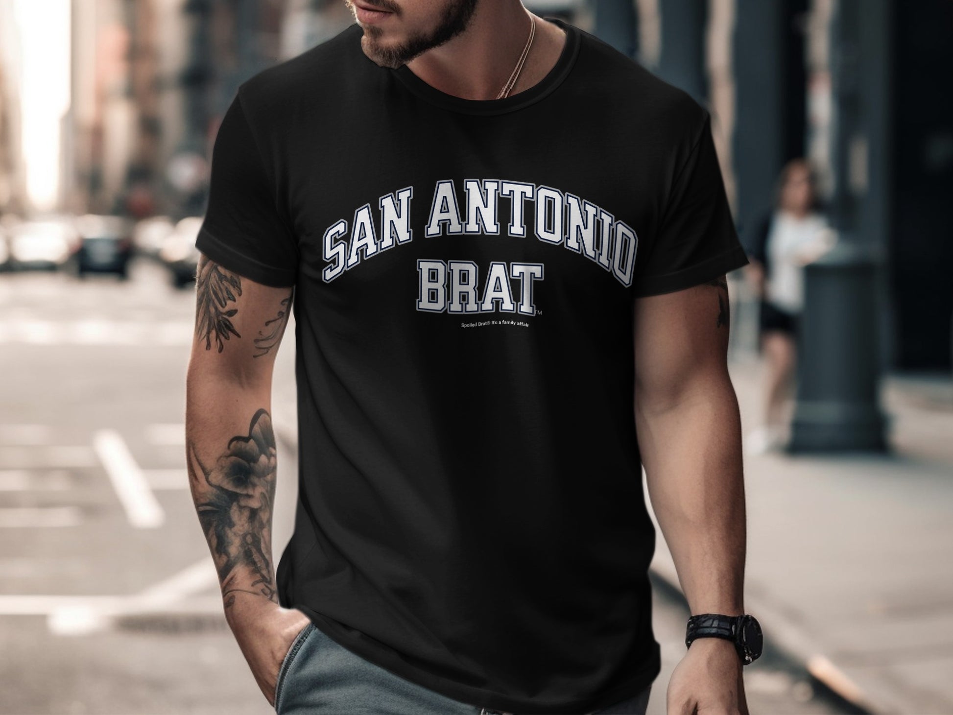 Black t-shirt with "SAN ANTONIO BRAT" text in white arched lettering.