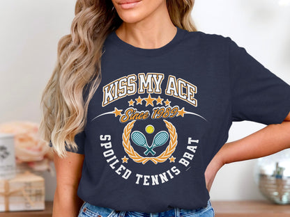 Navy t-shirt with "Kiss My Ace Spoiled Tennis Brat" and crossed rackets.