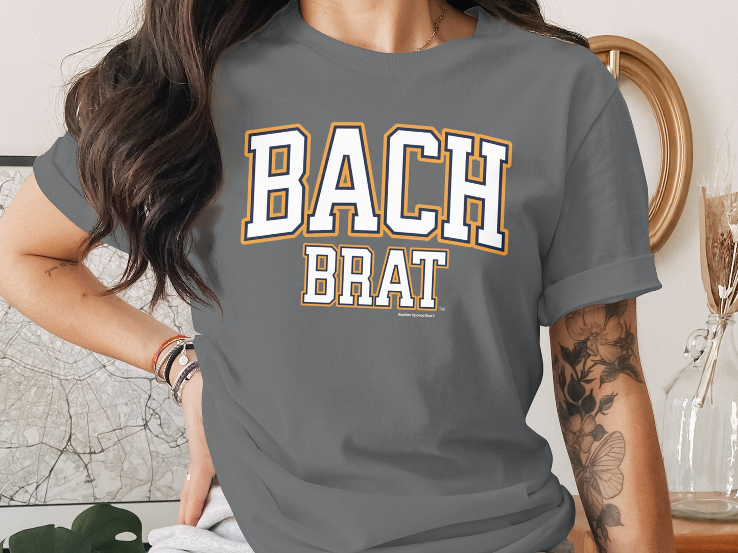 Grey t-shirt with "BACH BRAT" text, small text below reads "Another Spoiled Brat".