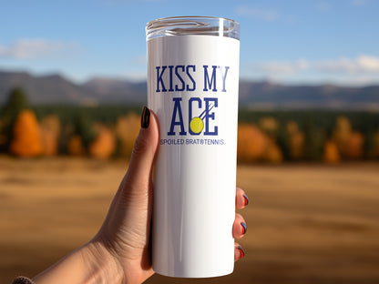 White tumbler with "KISS MY ACE" and a tennis ball, held by a hand.