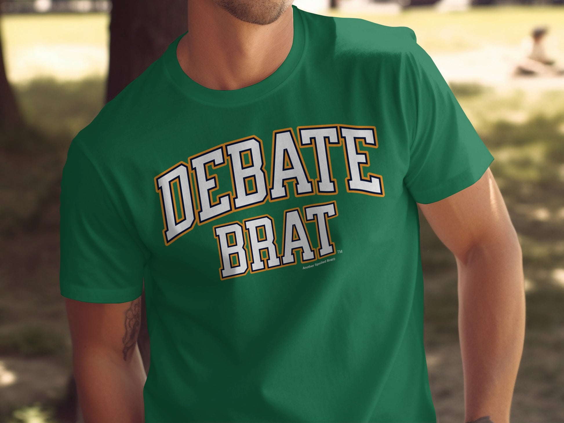 Green t-shirt with "DEBATE BRAT" text in white and yellow arching font.
