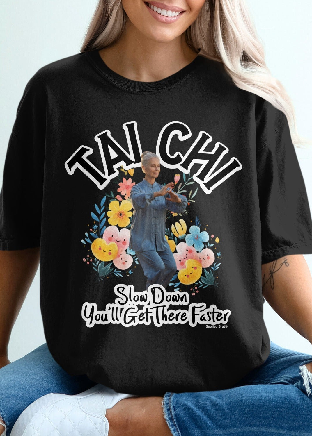 Black t-shirt with "Tai Chi" and floral design, person practicing Tai Chi.