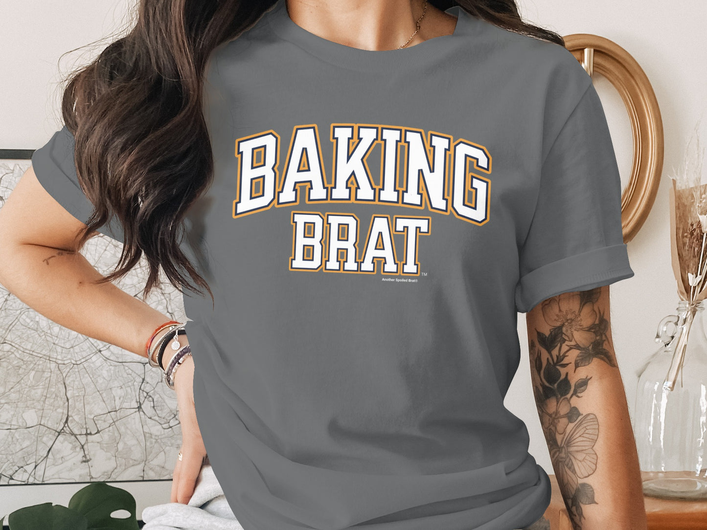 Grey t-shirt with "BAKING BRAT" text in collegiate font.