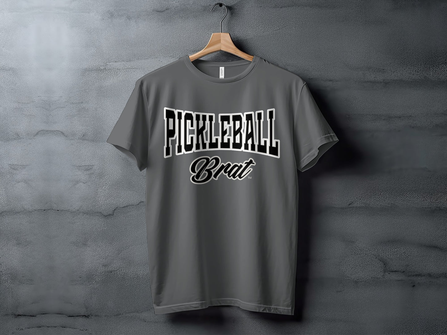 Grey t-shirt with "PICKLEBALL Brat" text in white and black lettering.