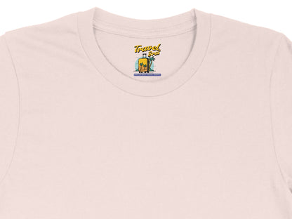 Pink t-shirt with "Travel Brat" suitcase and palm tree graphic; "Spoiled Brat Travel Agency" text.