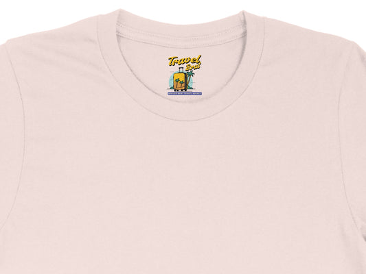 Pink t-shirt with "Travel Brat" suitcase and palm tree graphic; "Spoiled Brat Travel Agency" text.
