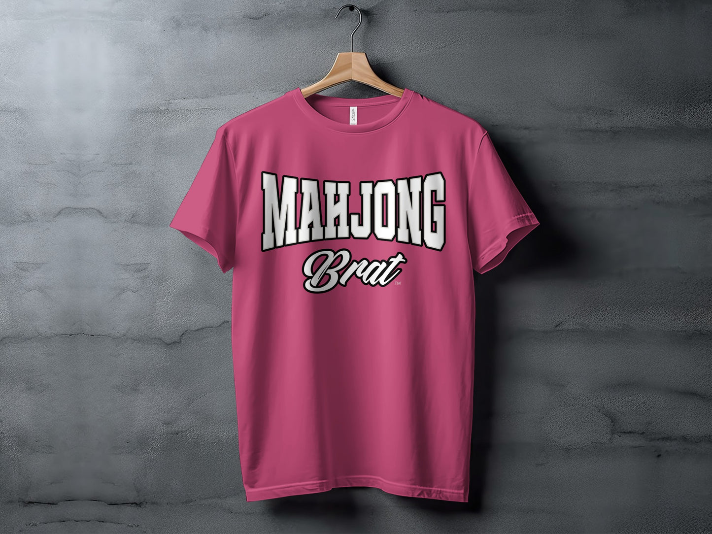Pink t-shirt with "MAHJONG Brat" text printed on the front.