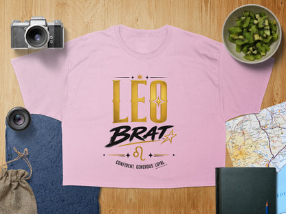 Pink t-shirt with gold "LEO BRAT" text and Leo zodiac symbol.