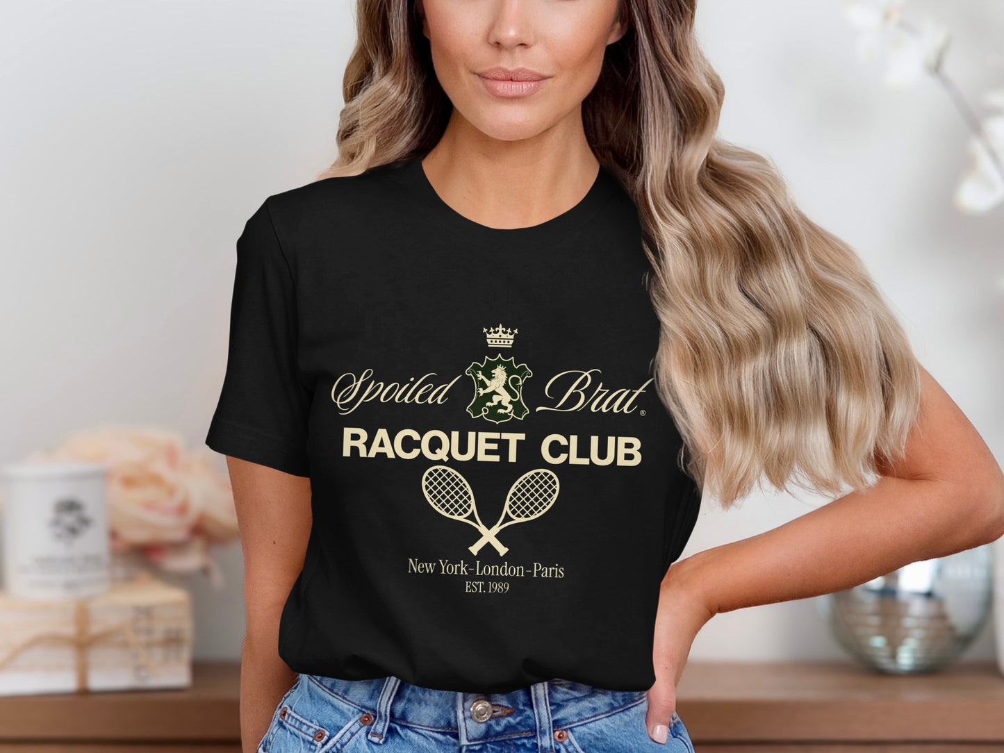 Black t-shirt with "Spoiled Brat Racquet Club" and crossed tennis racquets graphic.