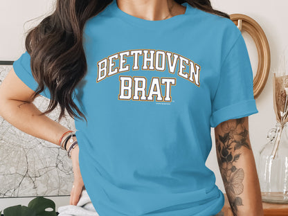 Blue t-shirt with white and yellow text that reads "BEETHOVEN BRAT".