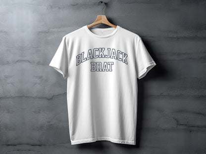 White t-shirt with navy blue text "BLACKJACK BRAT" arched across chest.