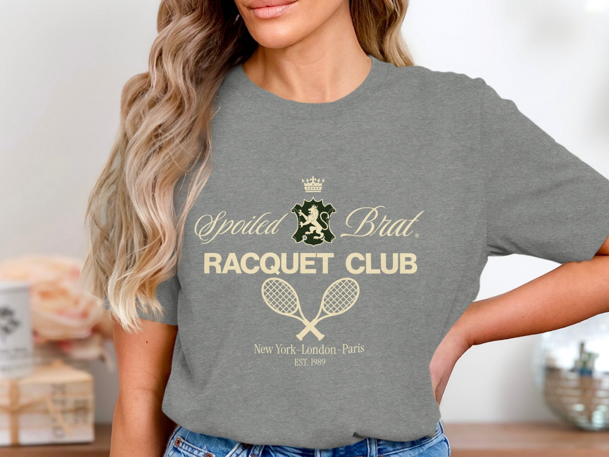 Grey t-shirt with "Spoiled Brat Racquet Club" and crossed tennis rackets.