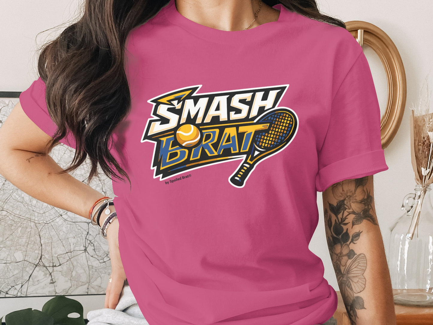 Pink t-shirt with "SMASH BRAT" text, tennis ball, and racket graphic.