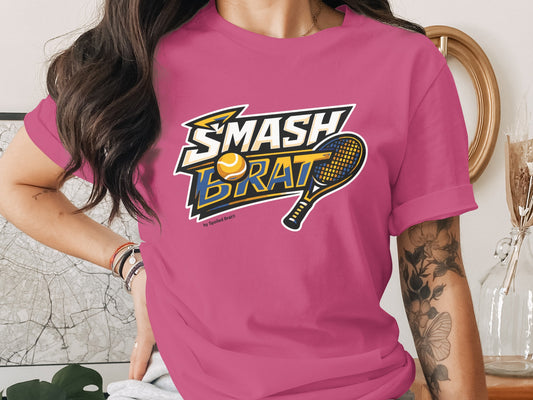 Pink t-shirt with "SMASH BRAT" text, tennis ball, and racket graphic.
