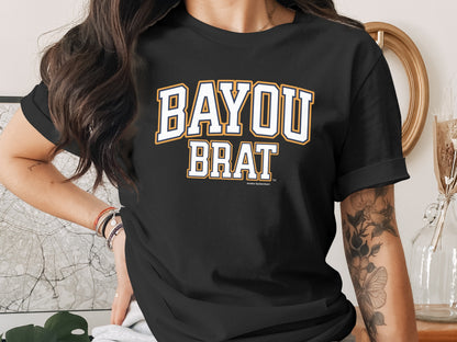 Black t-shirt with "BAYOU BRAT" text in white and yellow athletic font.