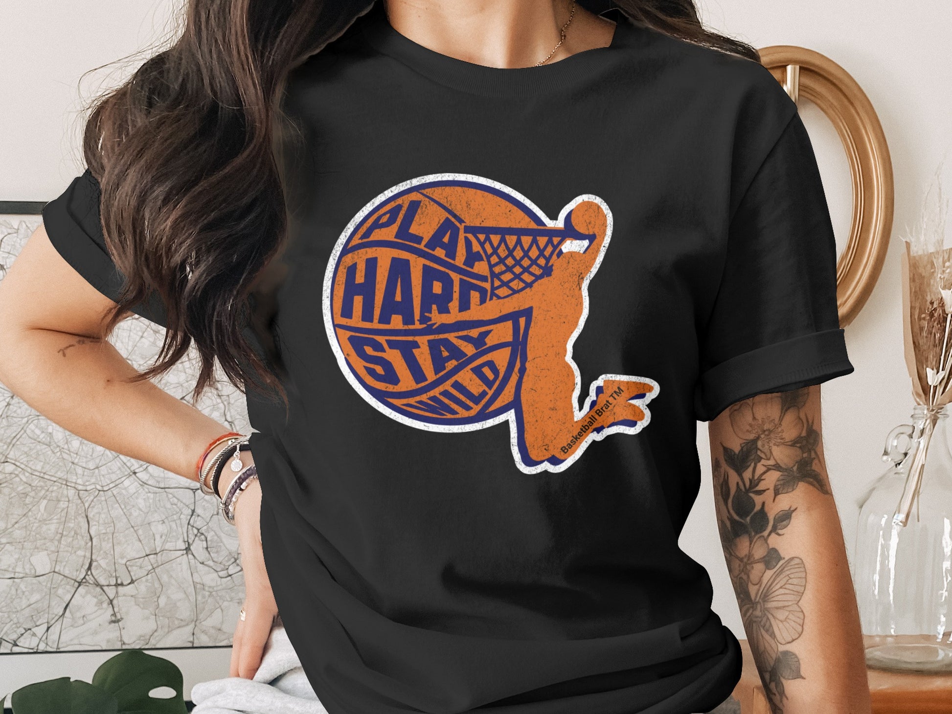 Black t-shirt with orange basketball player graphic and "Play Hard Stay Wild" text.