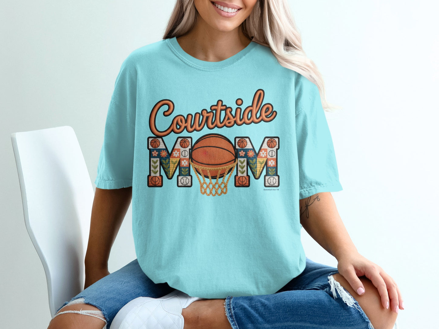 Turquoise t-shirt with "Courtside Mom" text and basketball hoop graphic.