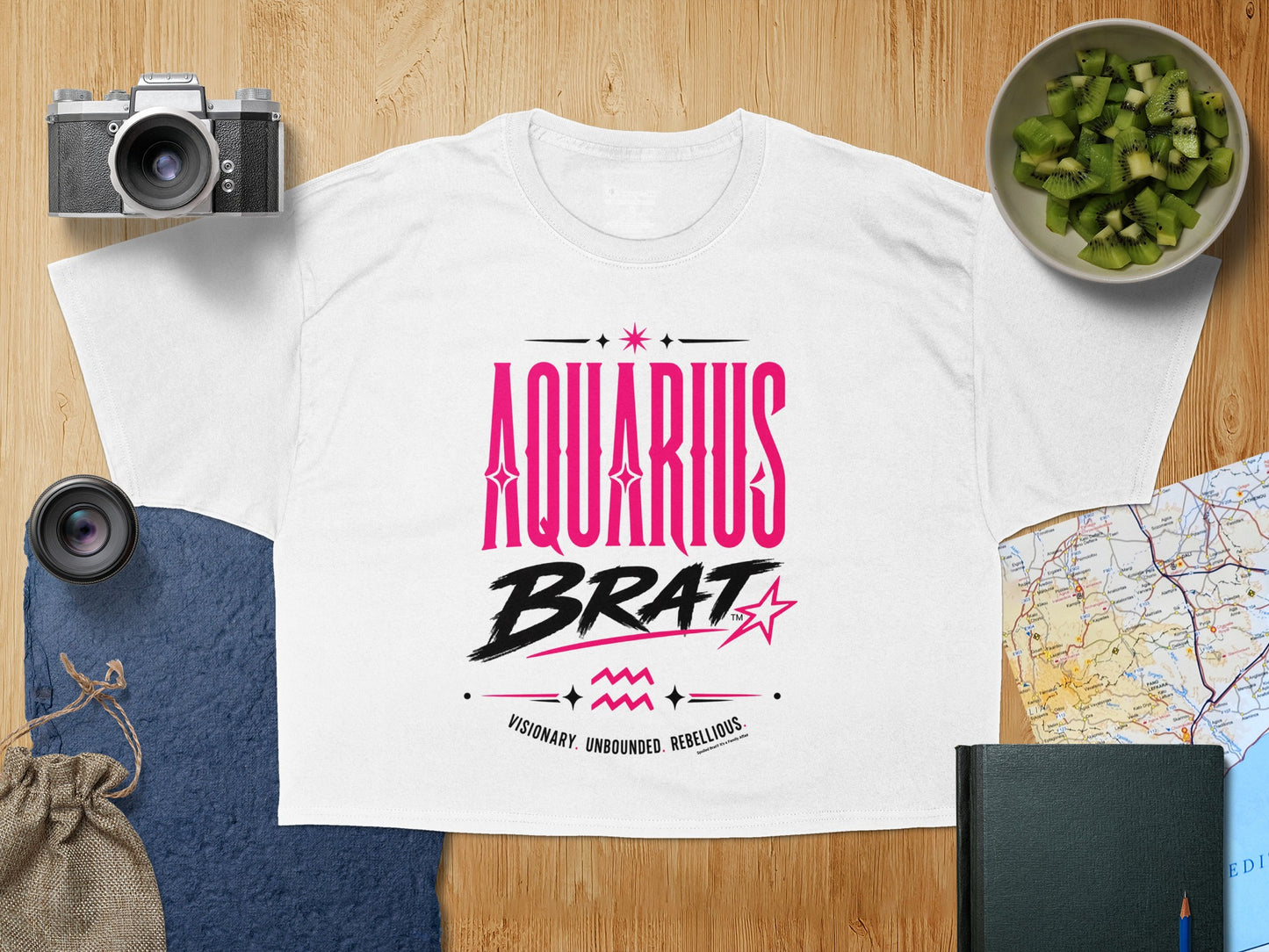 White t-shirt with "AQUARIUS BRAT" text and astrological symbols.