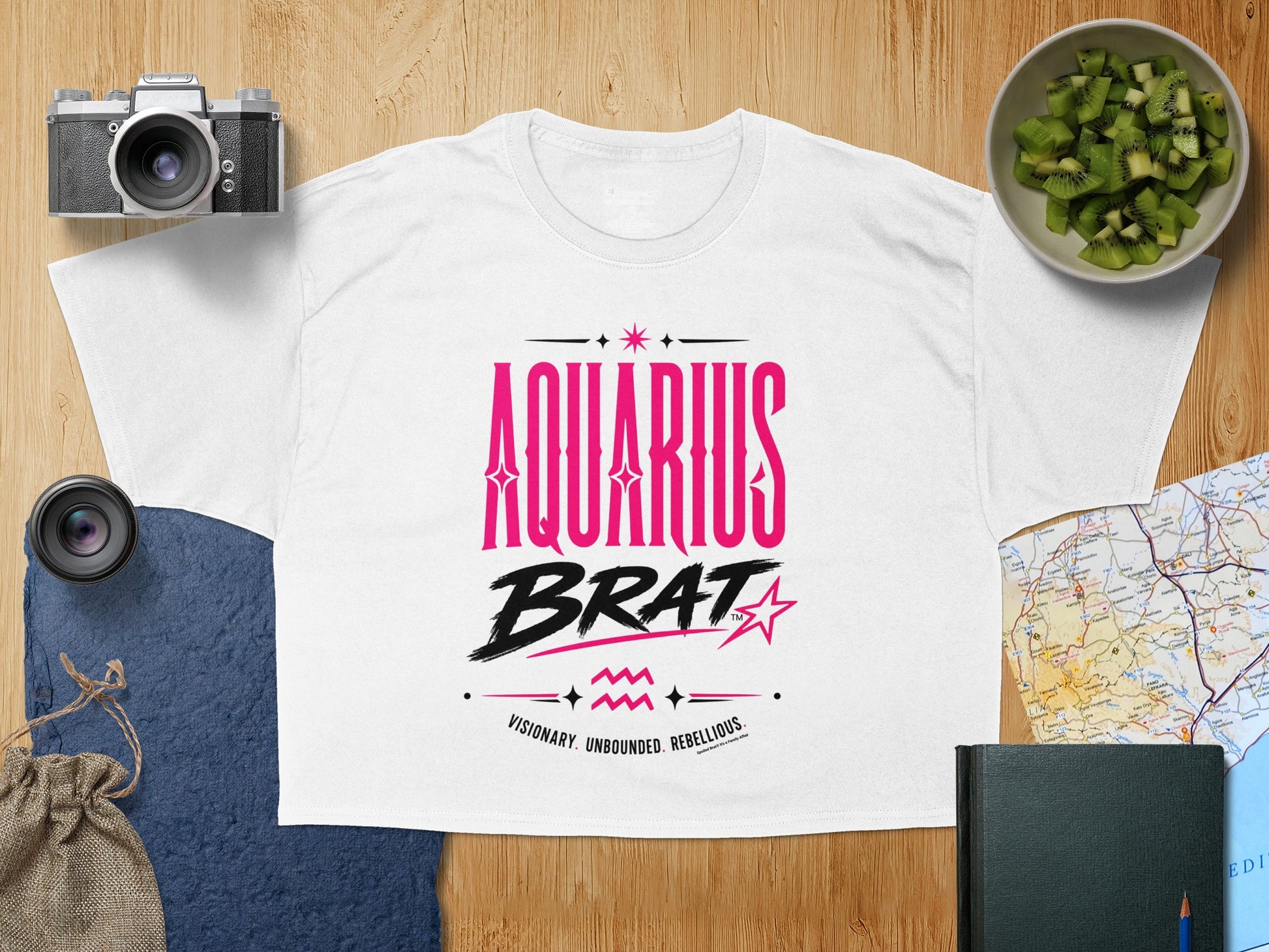 White t-shirt with "AQUARIUS BRAT" text and astrological symbols.