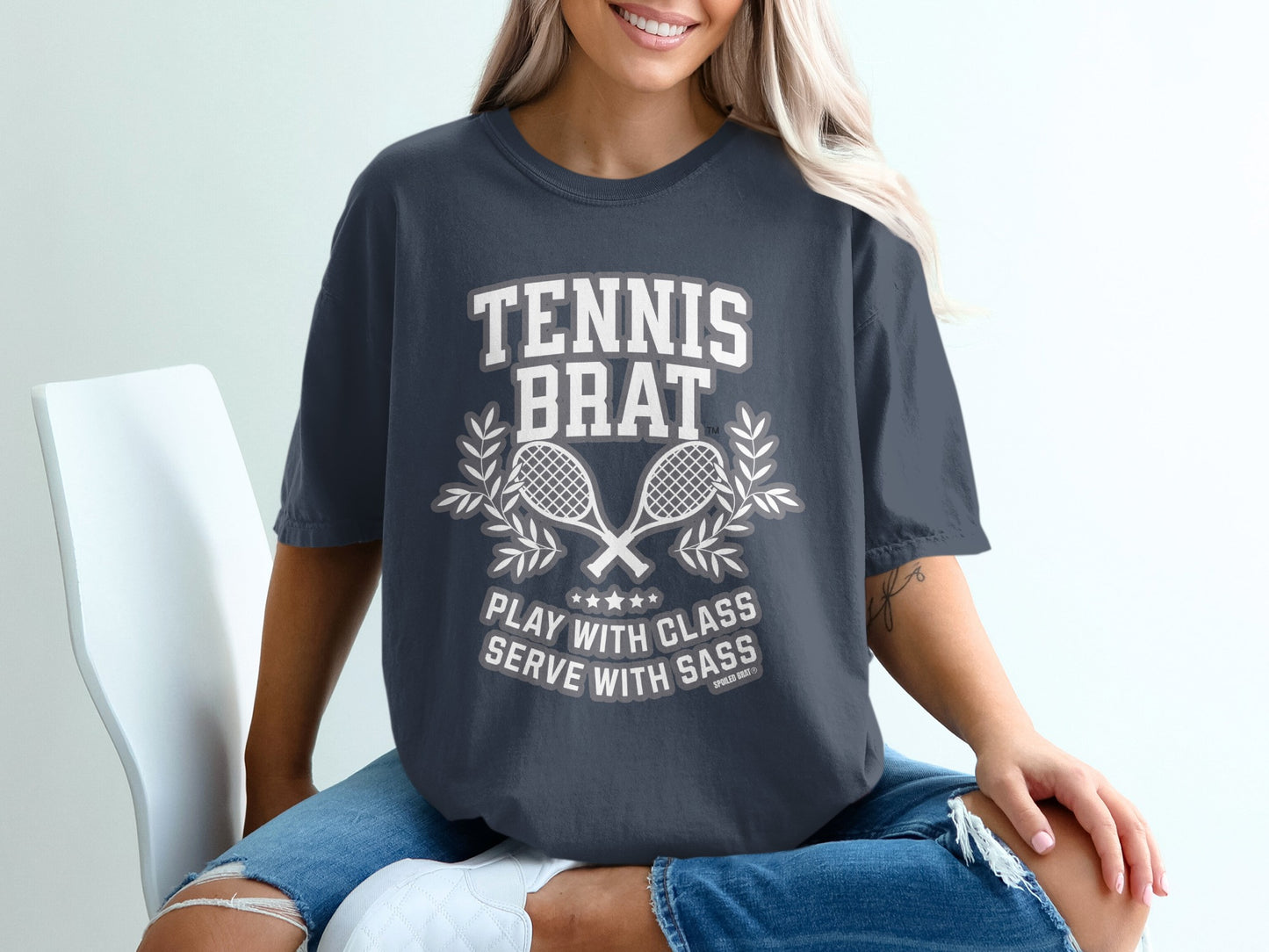 T-shirt with "TENNIS BRAT PLAY WITH CLASS SERVE WITH SASS" text and crossed rackets.