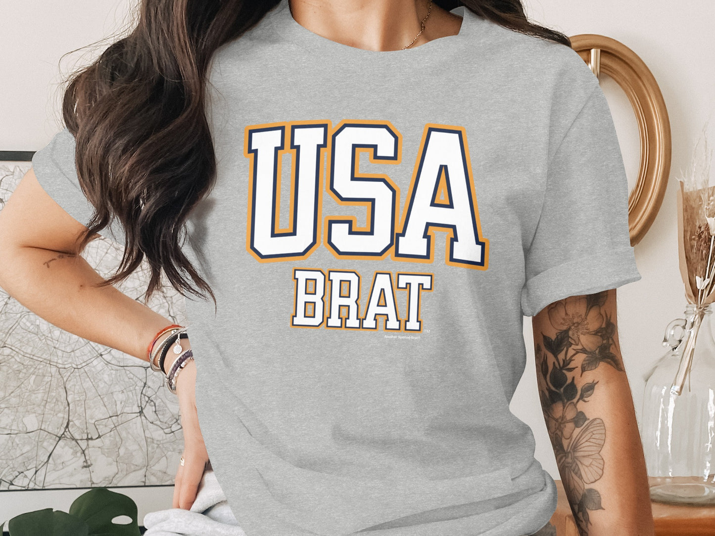 Gray t-shirt with "USA BRAT" text in white with blue and orange outline