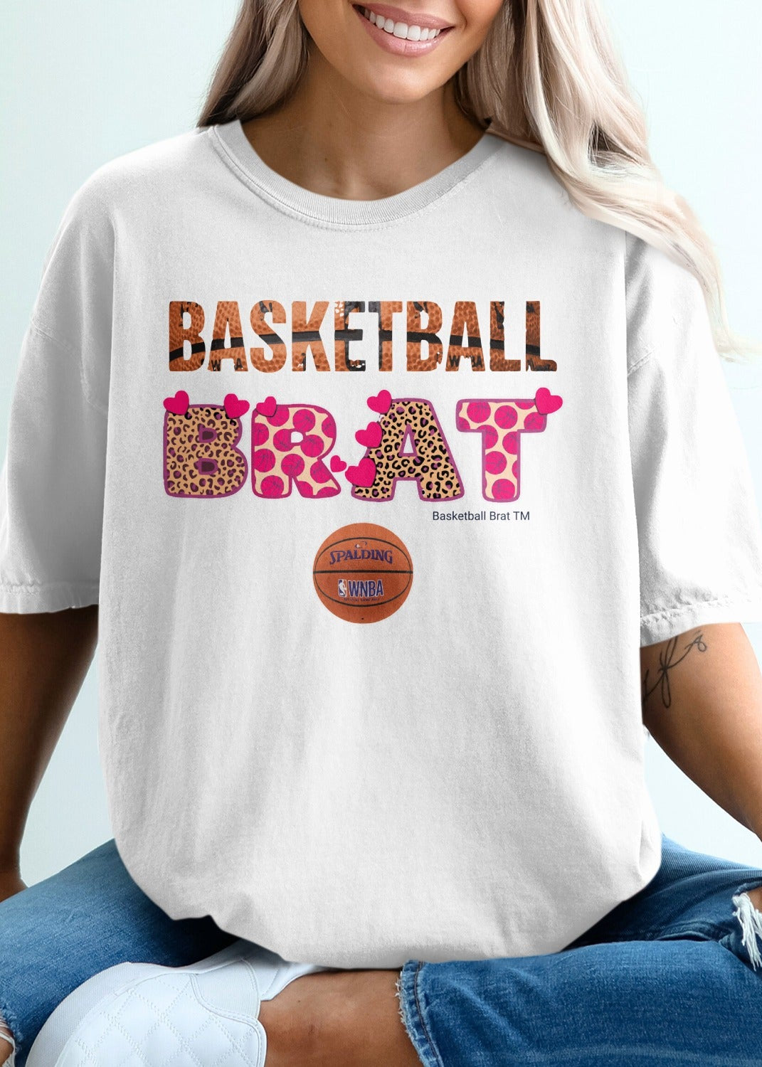 White t-shirt with "BASKETBALL BRAT" in leopard print and heart designs.