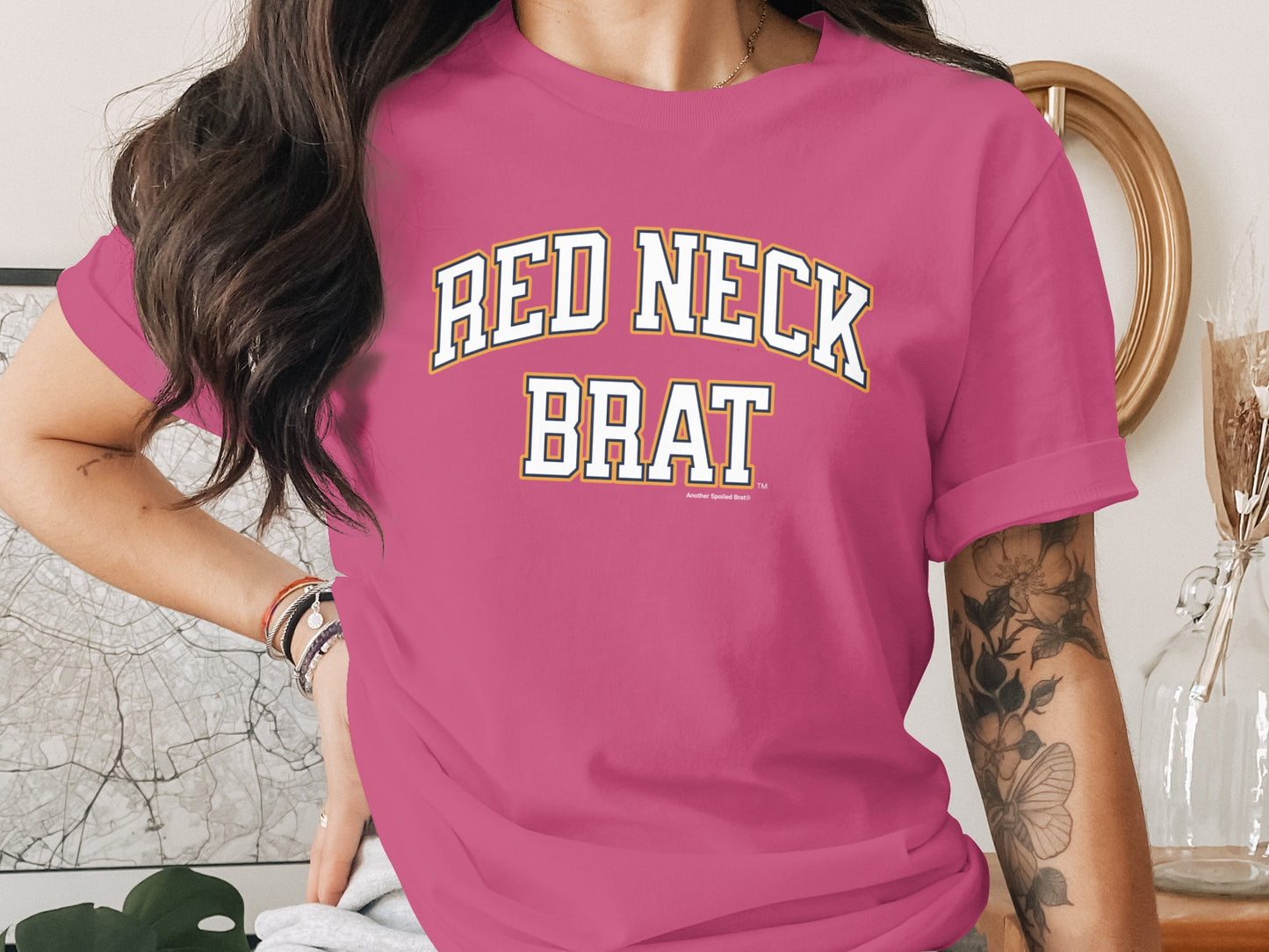Pink t-shirt with "RED NECK BRAT" text.