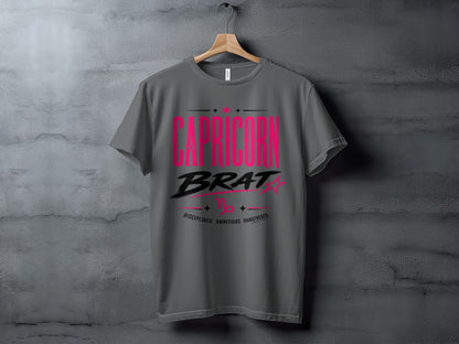 Grey t-shirt with "CAPRICORN BRAT" in pink and black stylized text.