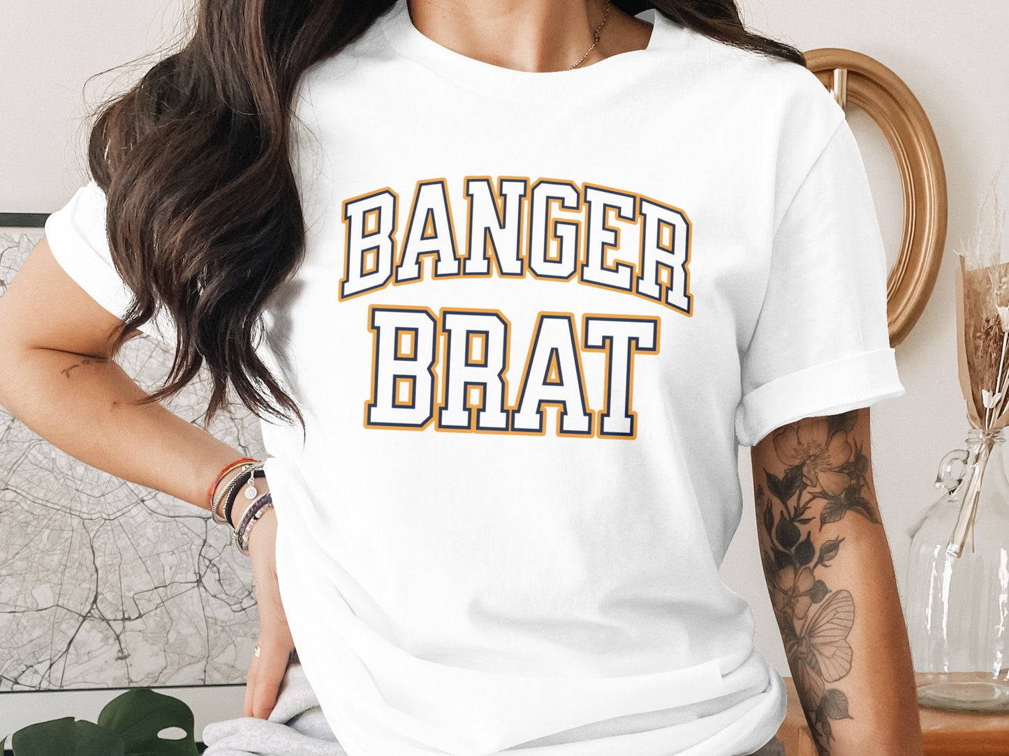 White t-shirt with "BANGER BRAT" text in blue and orange collegiate lettering.