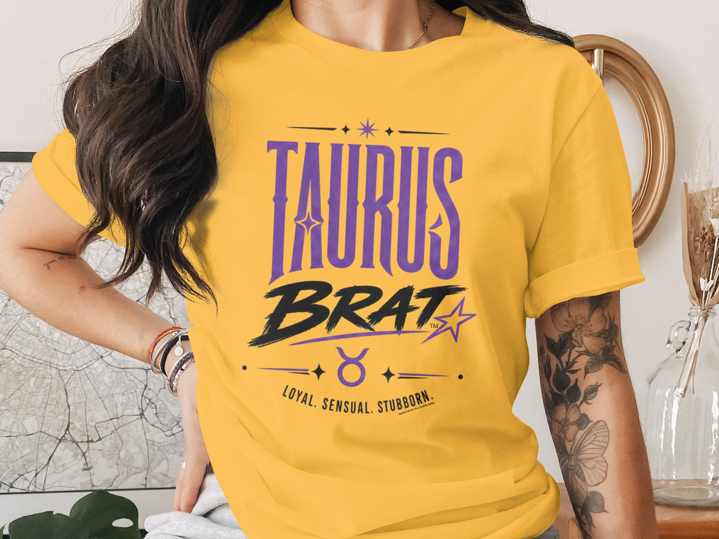 Yellow t-shirt with "TAURUS BRAT LOYAL. SENSUAL. STUBBORN." text.