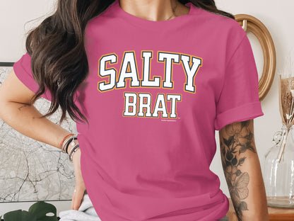 Pink t-shirt with "SALTY BRAT" text and "Another Spoiled Brat" trademark.