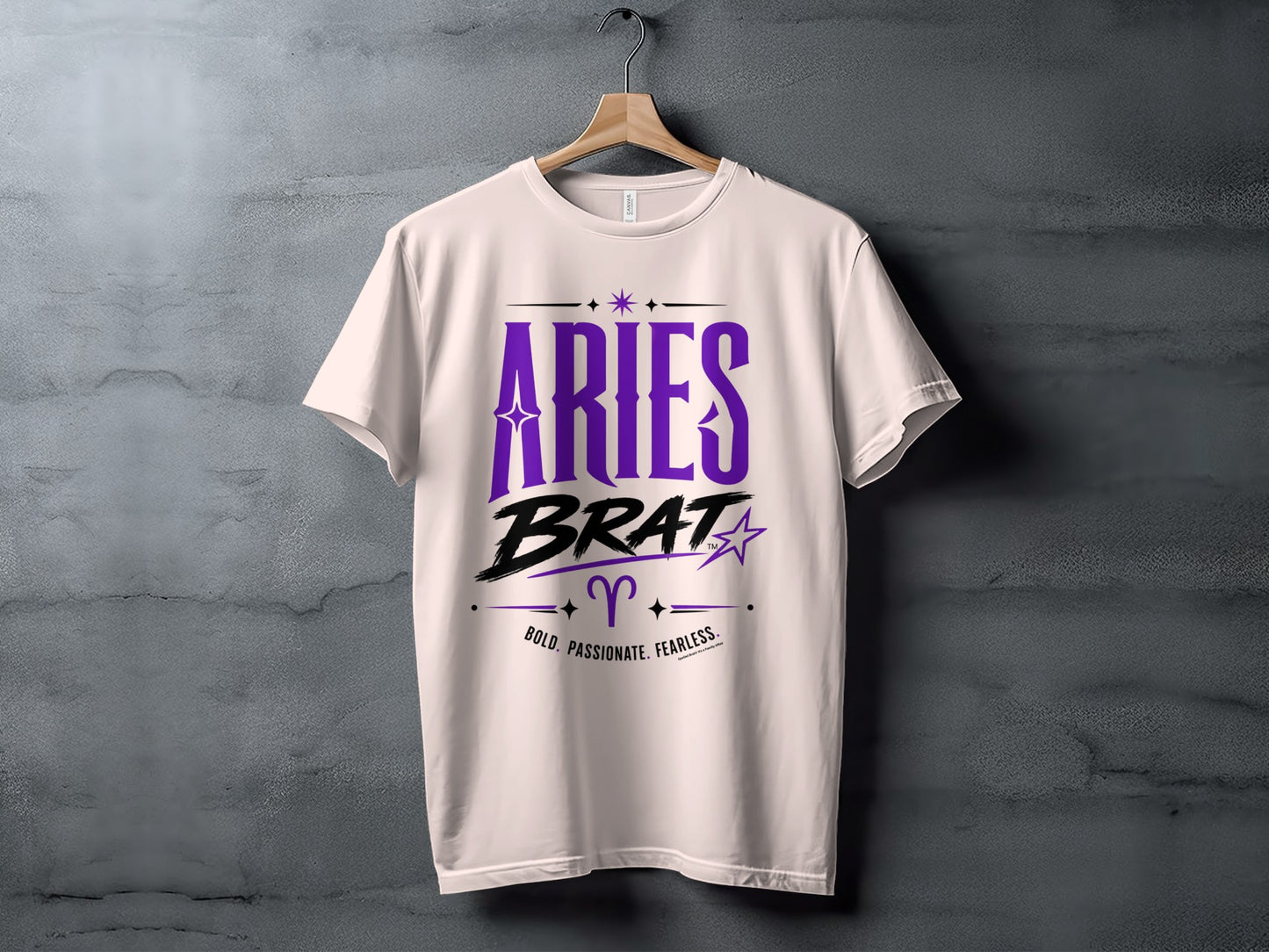 White t-shirt with "Aries Brat" text, Aries symbol, and "Bold. Passionate. Fearless." tagline.