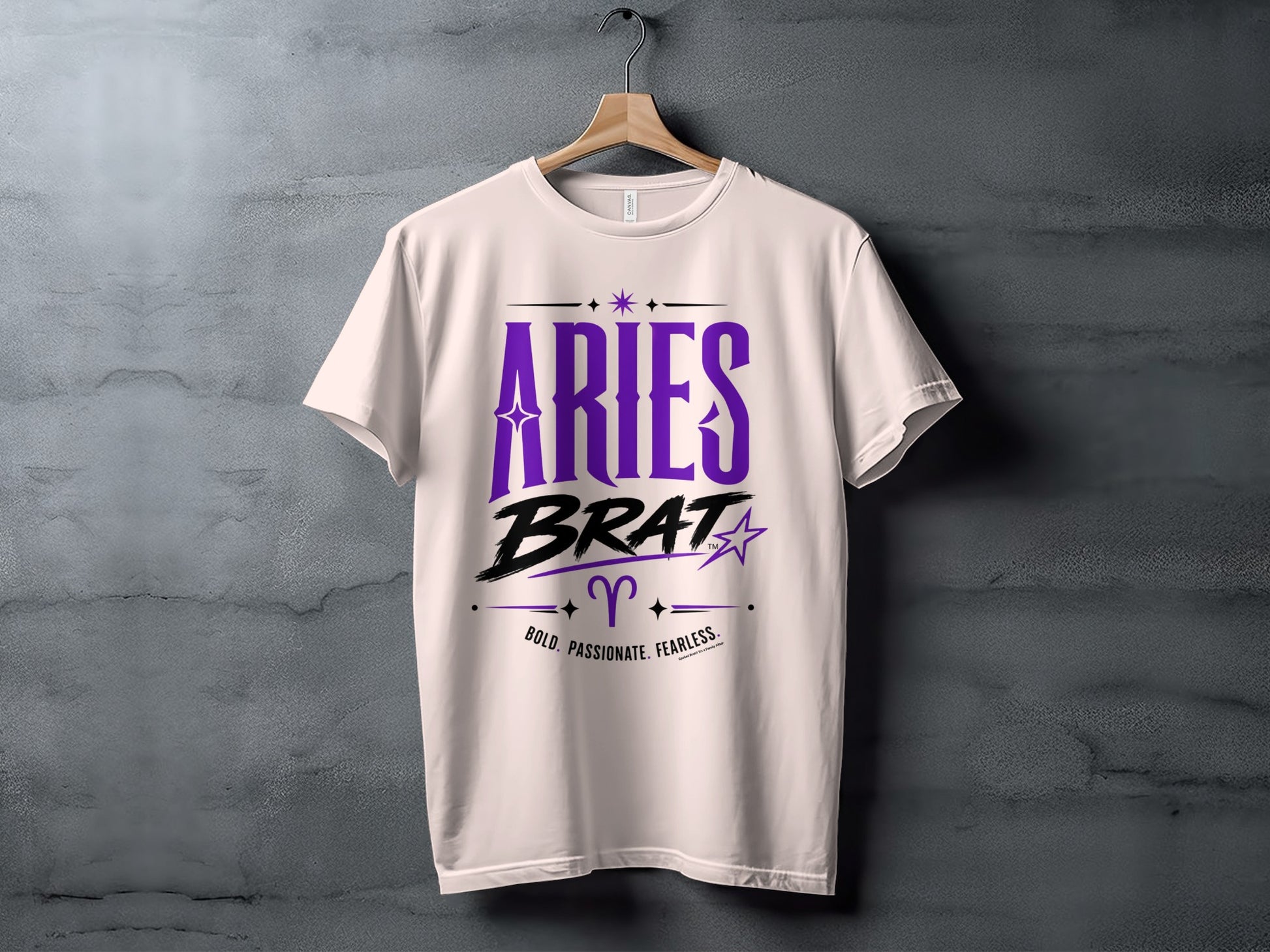 White t-shirt with "Aries Brat" text, Aries symbol, and "Bold. Passionate. Fearless." tagline.