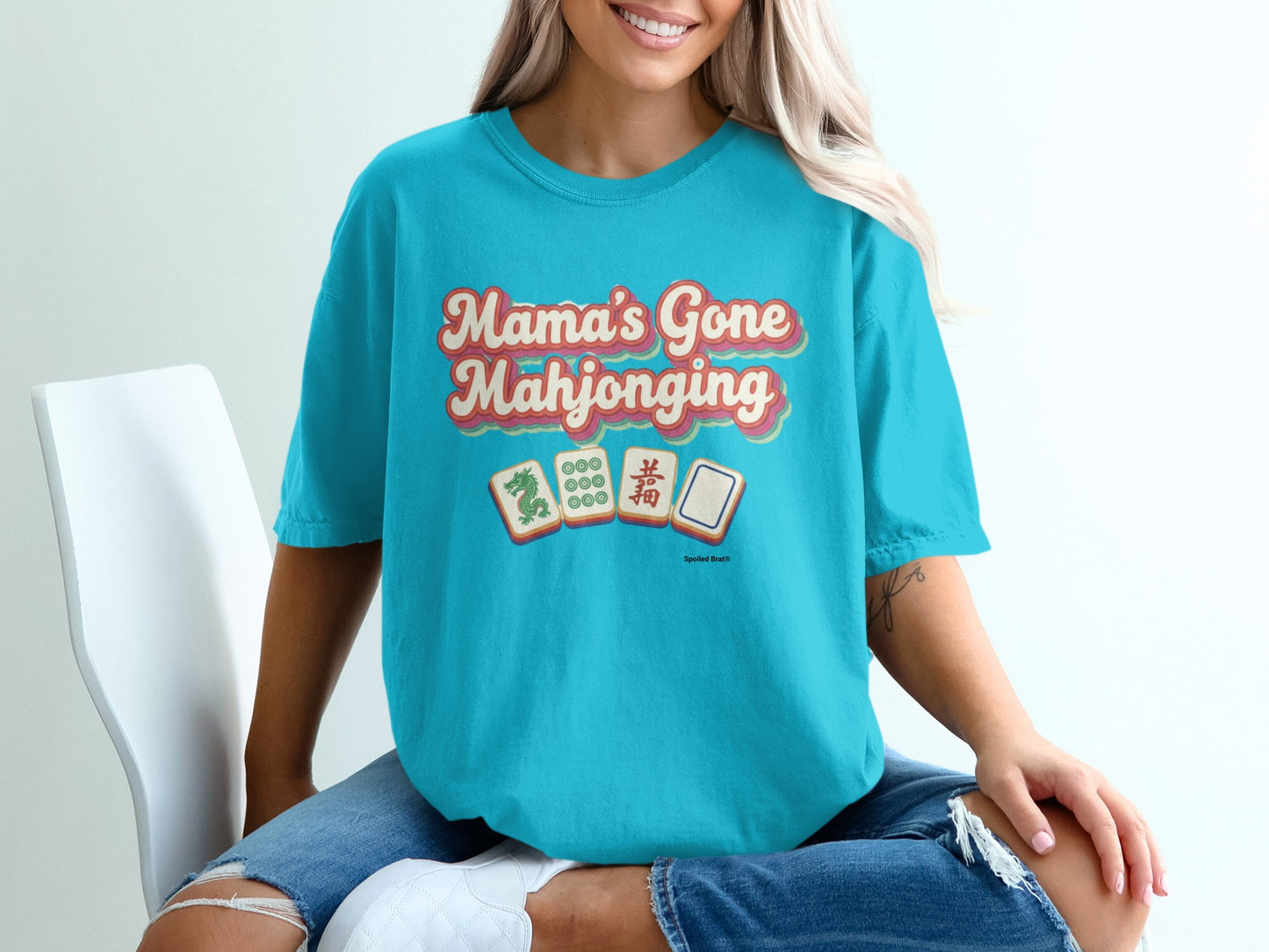 Turquoise t-shirt with "Mama's Gone Mahjonging" and mahjong tiles.