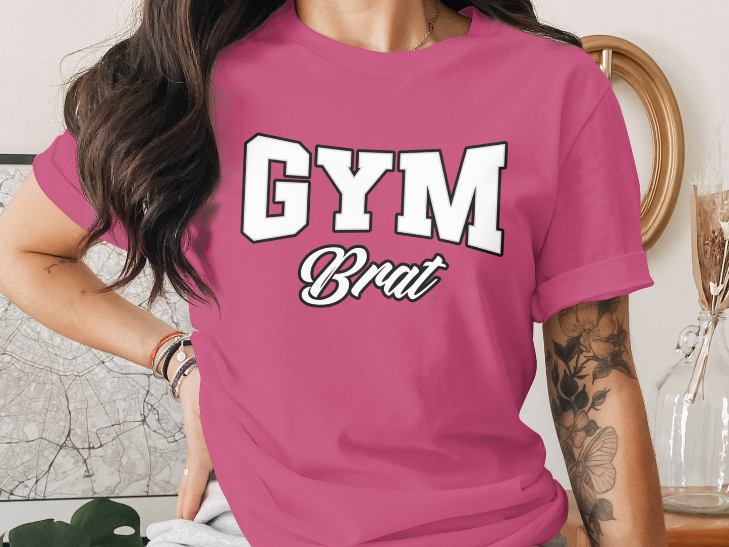 Pink t-shirt with "GYM Brat" graphic in white letters with black outline.