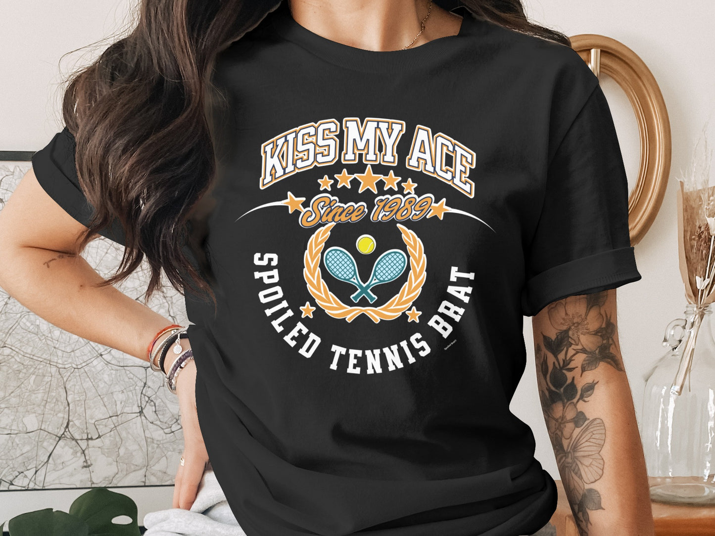 Black t-shirt with "Kiss My Ace Spoiled Tennis Brat" text and tennis graphics.