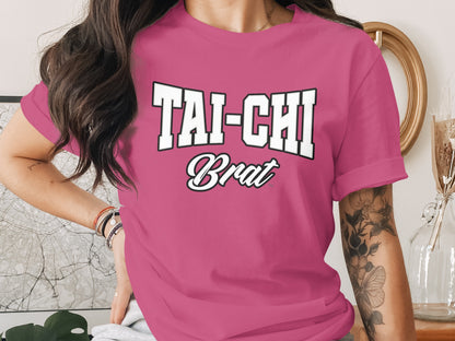 Pink t-shirt with "TAI-CHI Brat" text graphic.
