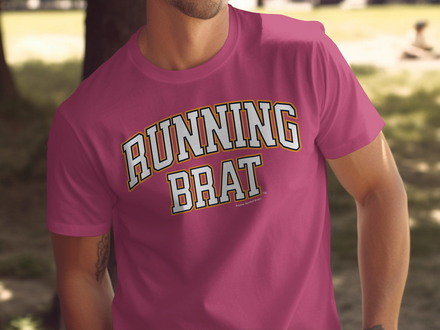 Pink t-shirt with "RUNNING BRAT" text in collegiate-style lettering.