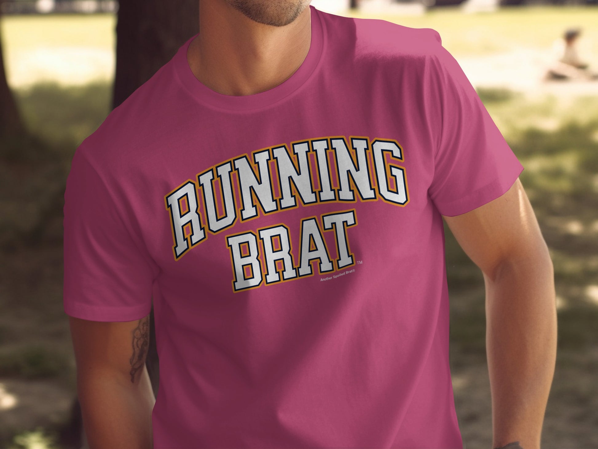 Pink t-shirt with "RUNNING BRAT" text in collegiate-style lettering.