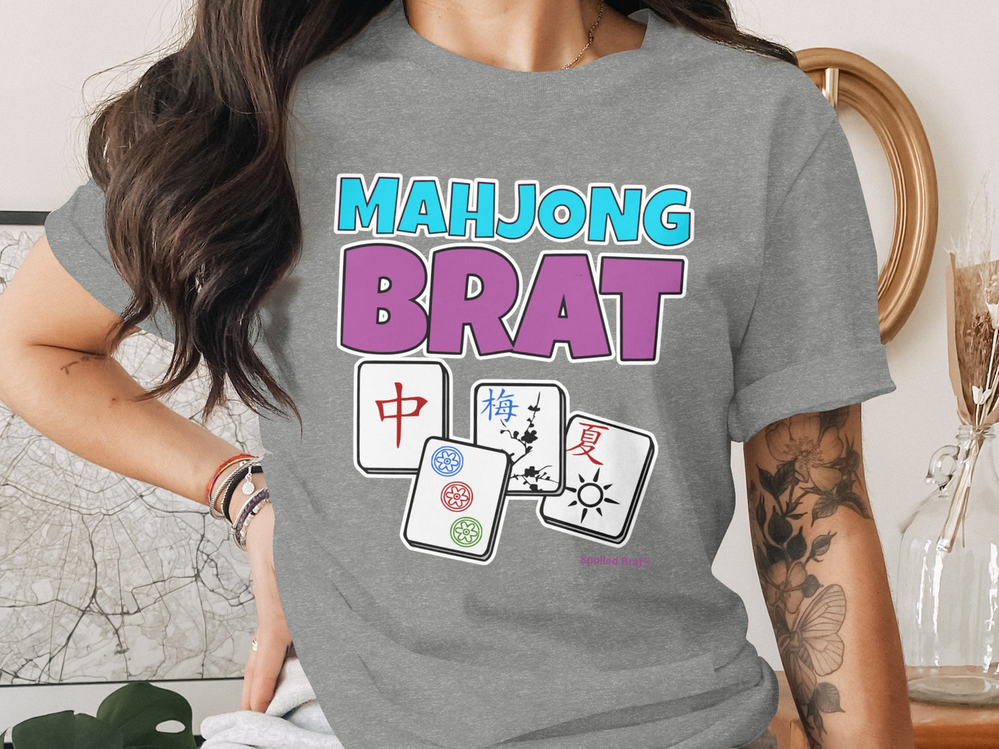 Gray t-shirt with pink "BRAT" and blue "MAHJONG" text and mahjong tiles.