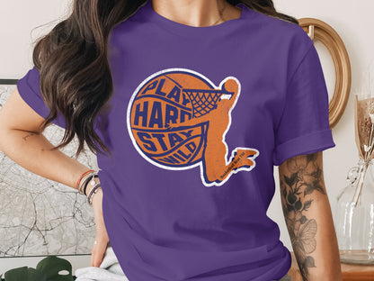 Purple t-shirt with orange basketball player graphic and text.
