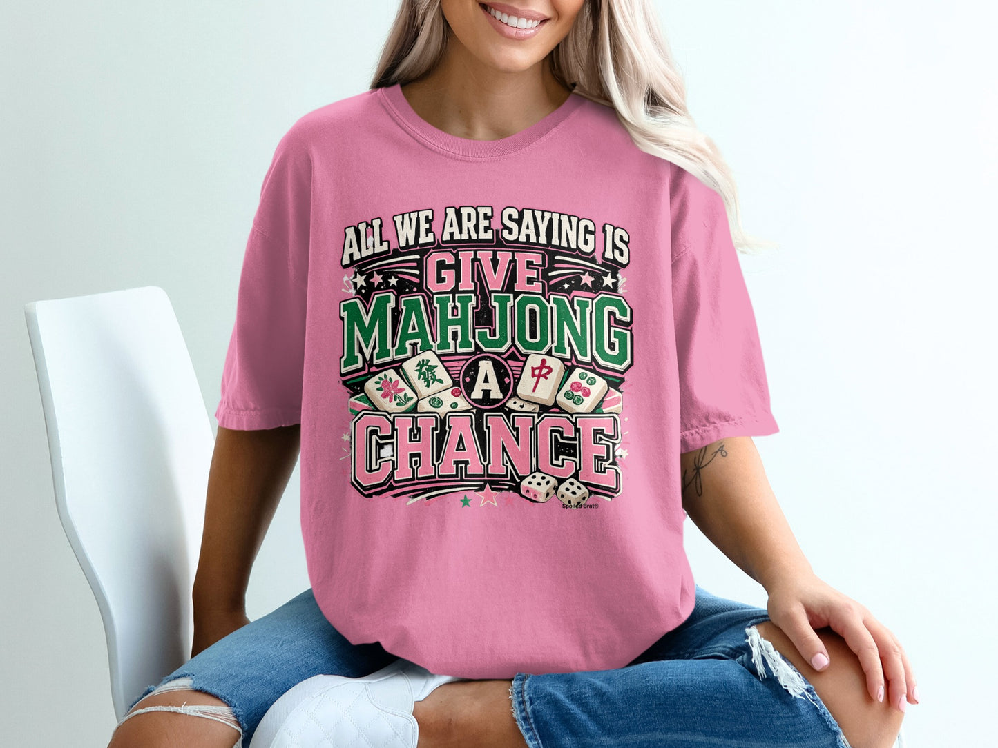 Pink t-shirt with "All We Are Saying Is Give Mahjong A Chance" text.