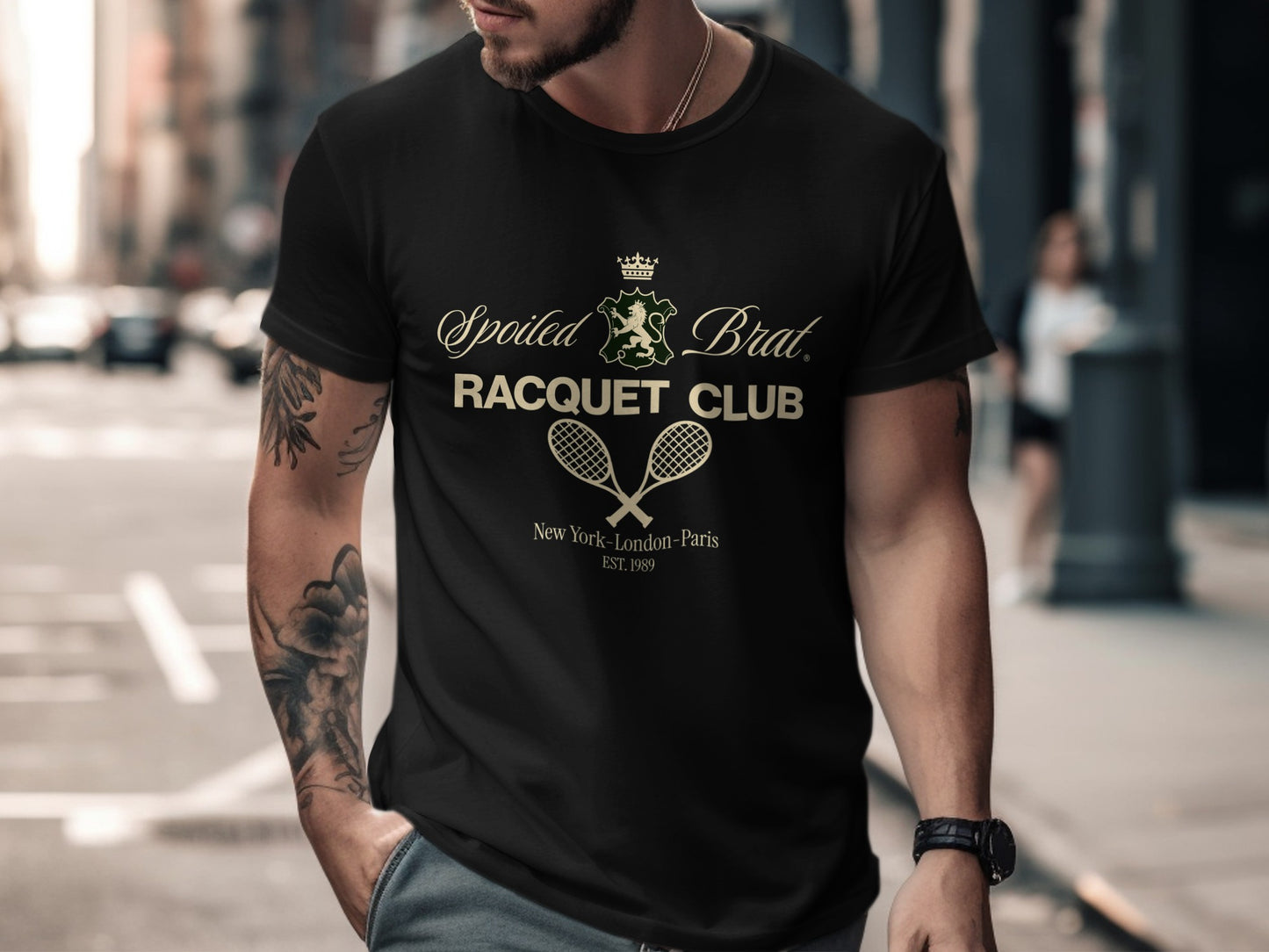 Black t-shirt with "Spoiled Brat. Racquet Club" logo and "New York - London - Paris Est. 1989".