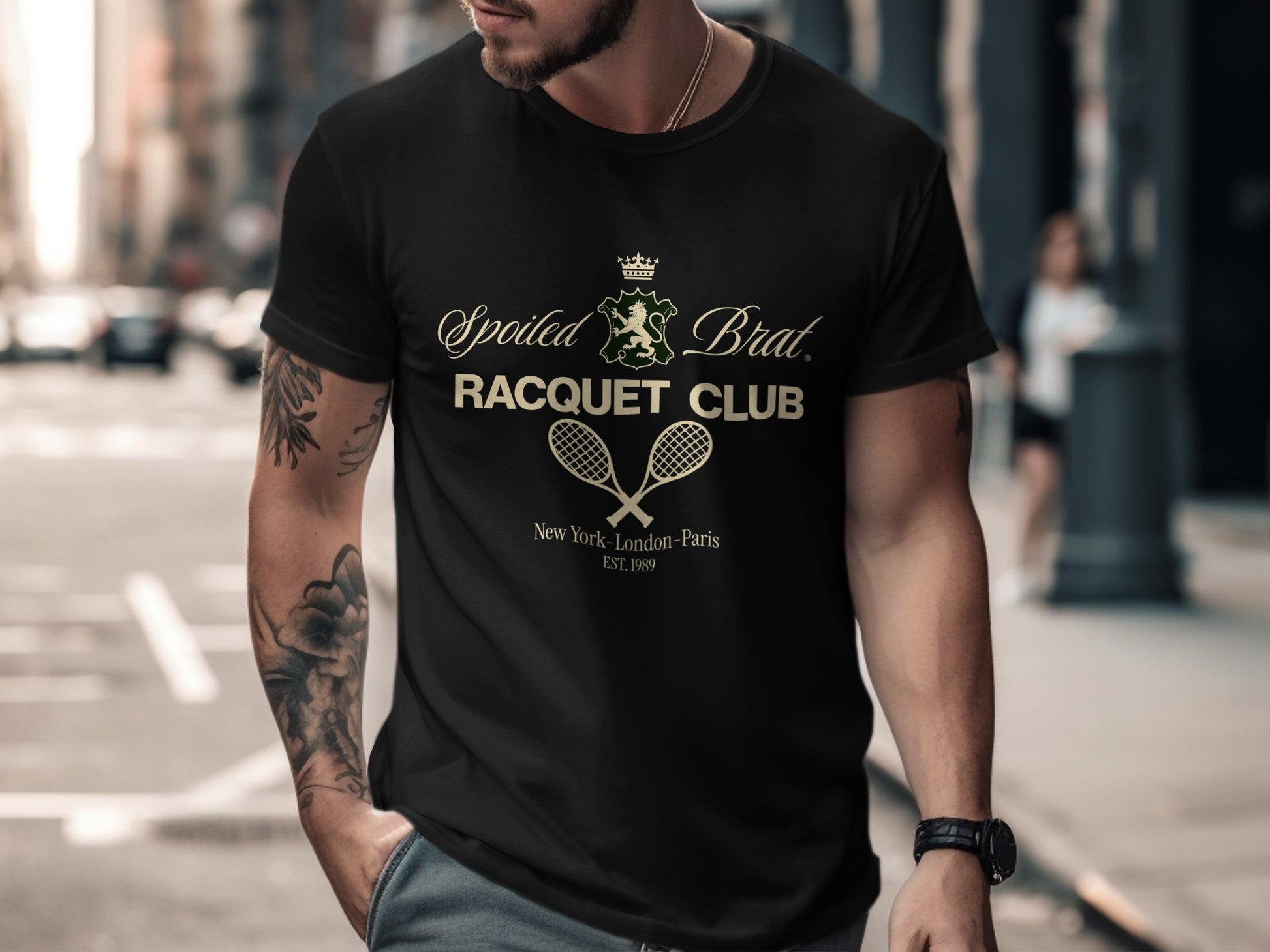 Black t-shirt with "Spoiled Brat. Racquet Club" logo and "New York - London - Paris Est. 1989".