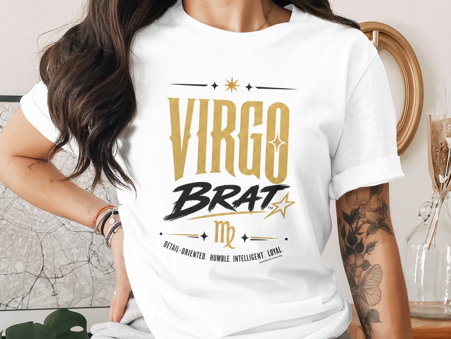 White t-shirt with gold "VIRGO BRAT" text, Virgo symbol, and traits.