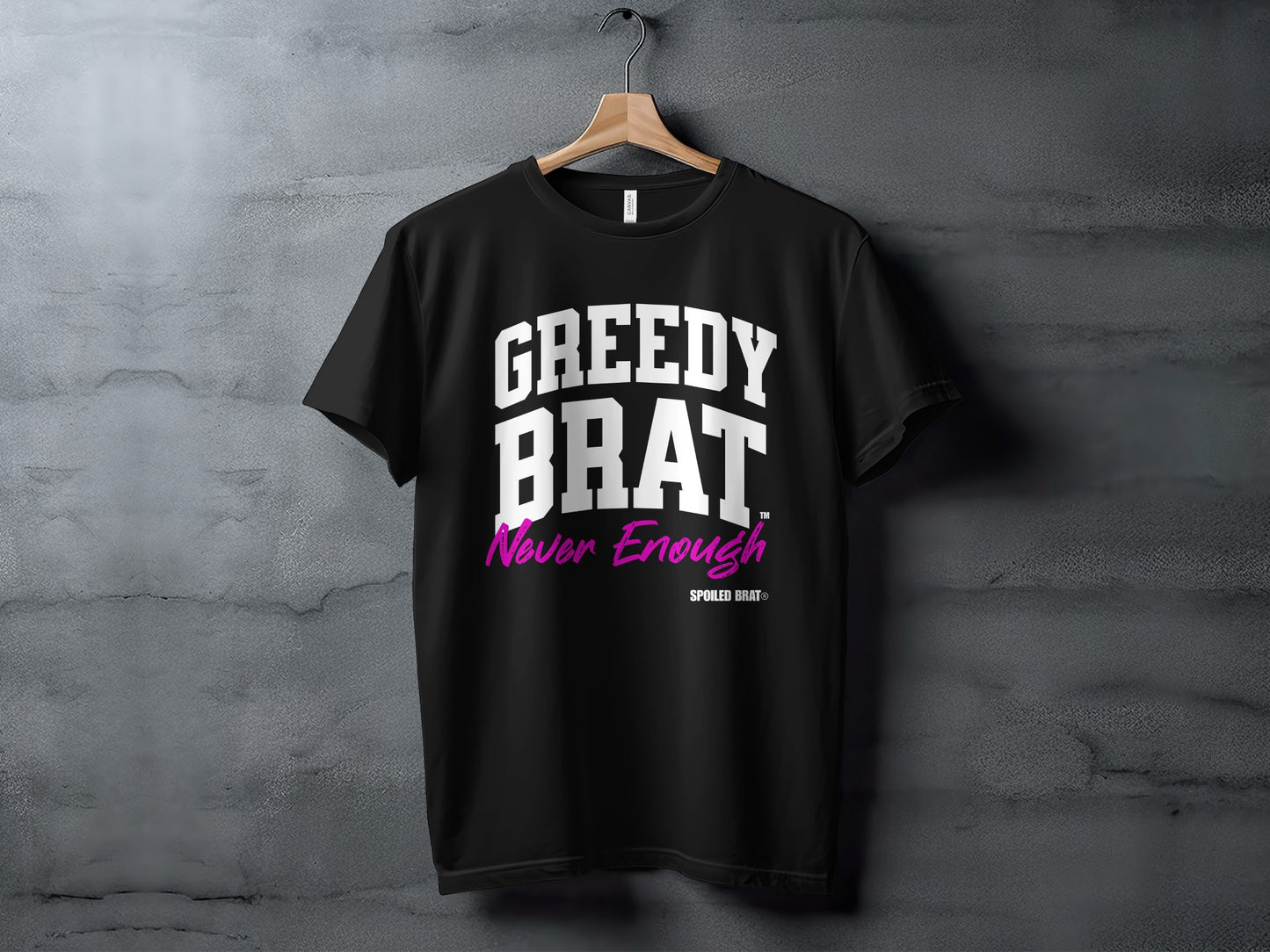 Black t-shirt with "GREEDY BRAT Never Enough" in white and pink text.