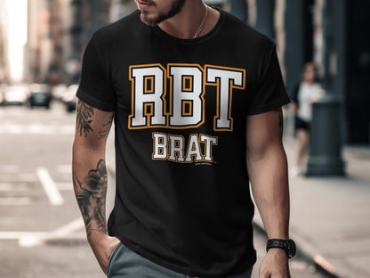 Black t-shirt with "RBT BRAT" text in white with yellow and navy trim.